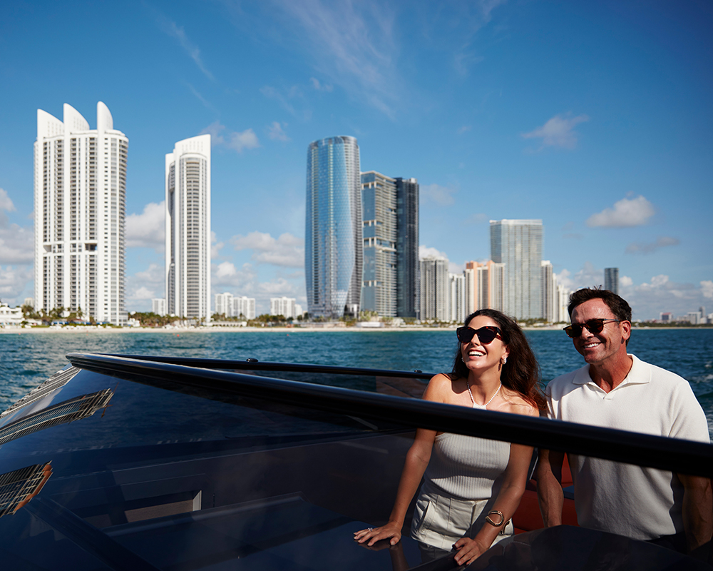 A happy couple on a boat along to the Sunny Isles Beach coast