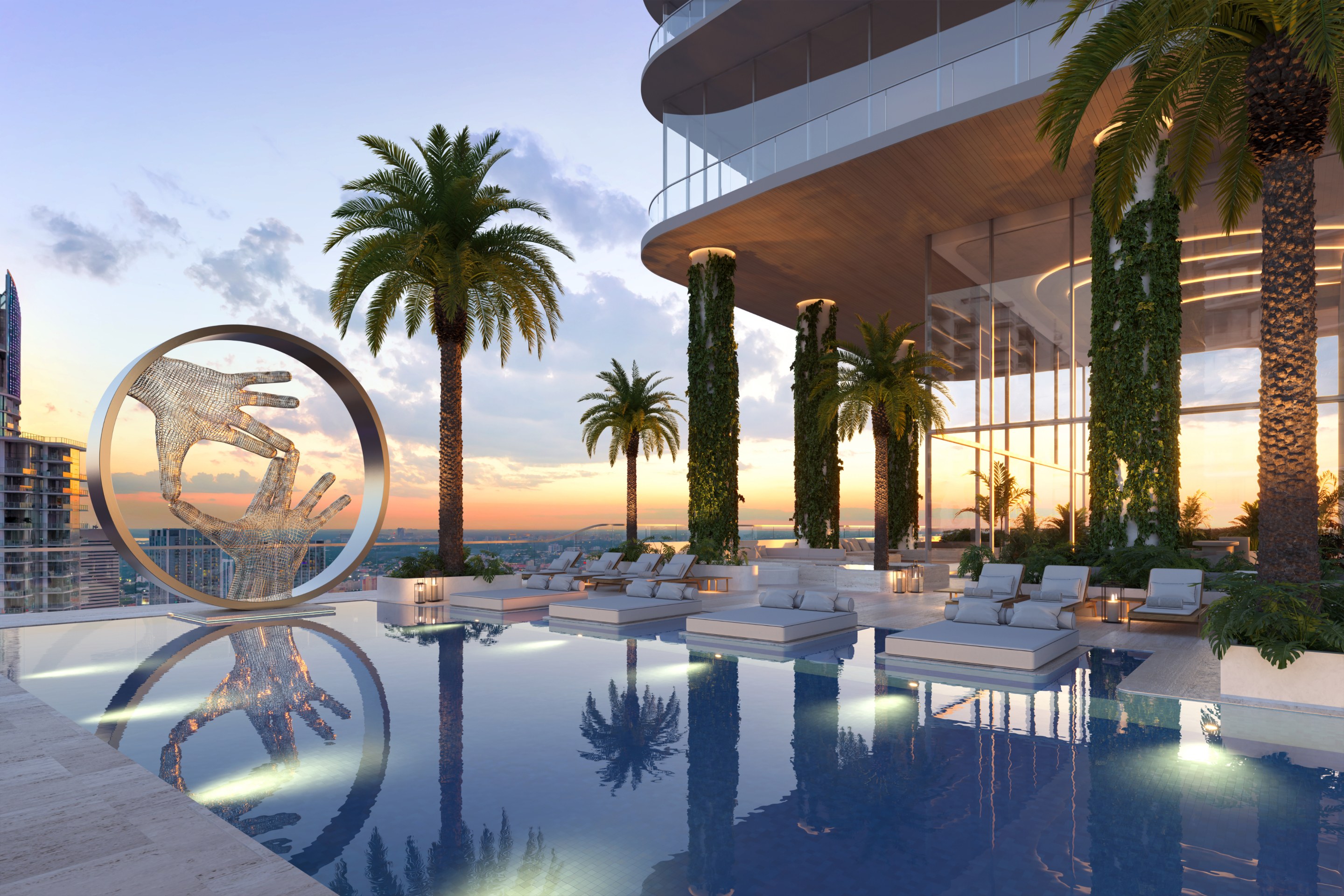 Side view of outdoor Miami pool with outside beds, a sculpture of two hands together