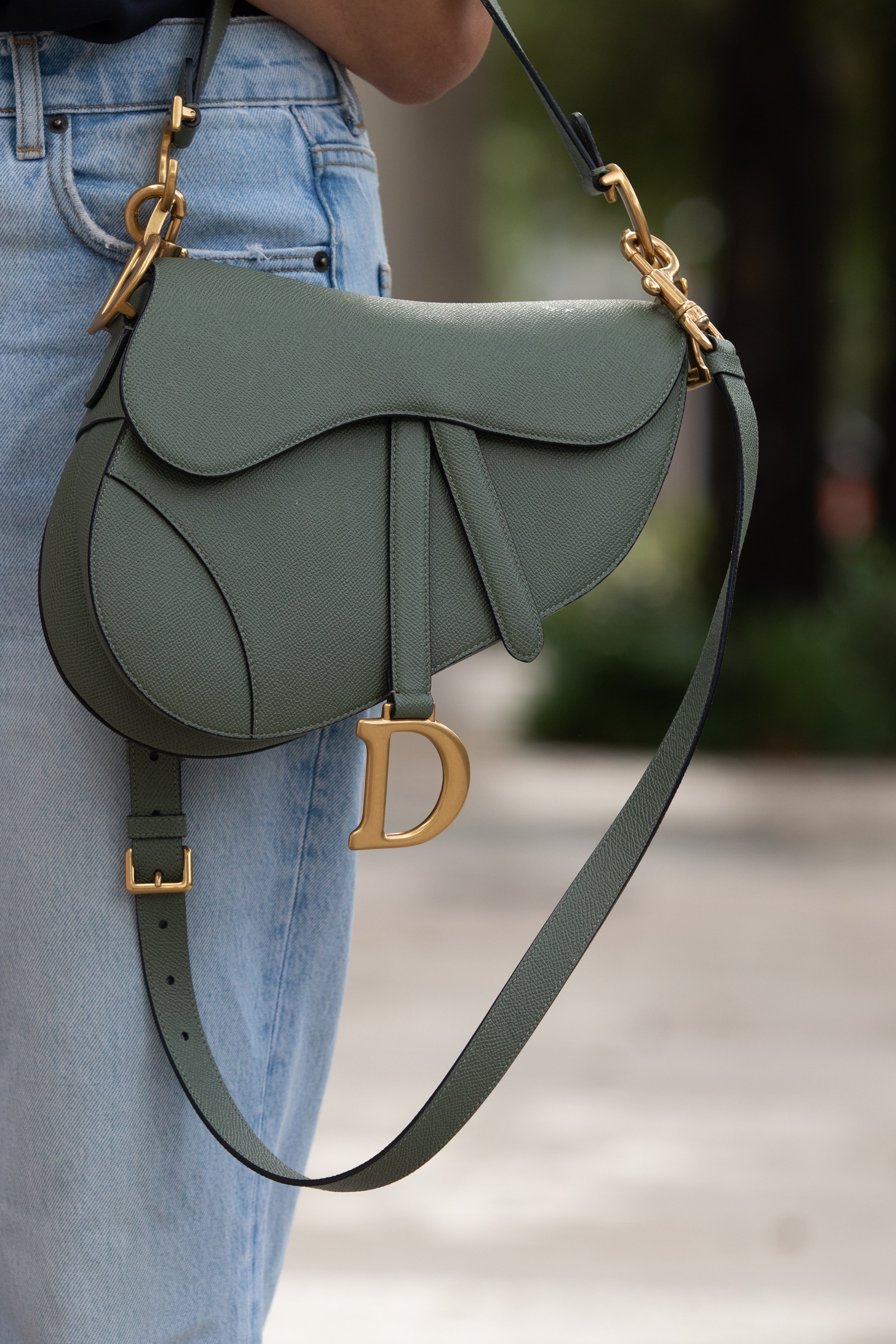 Grey Dior bag on woman's shoulder