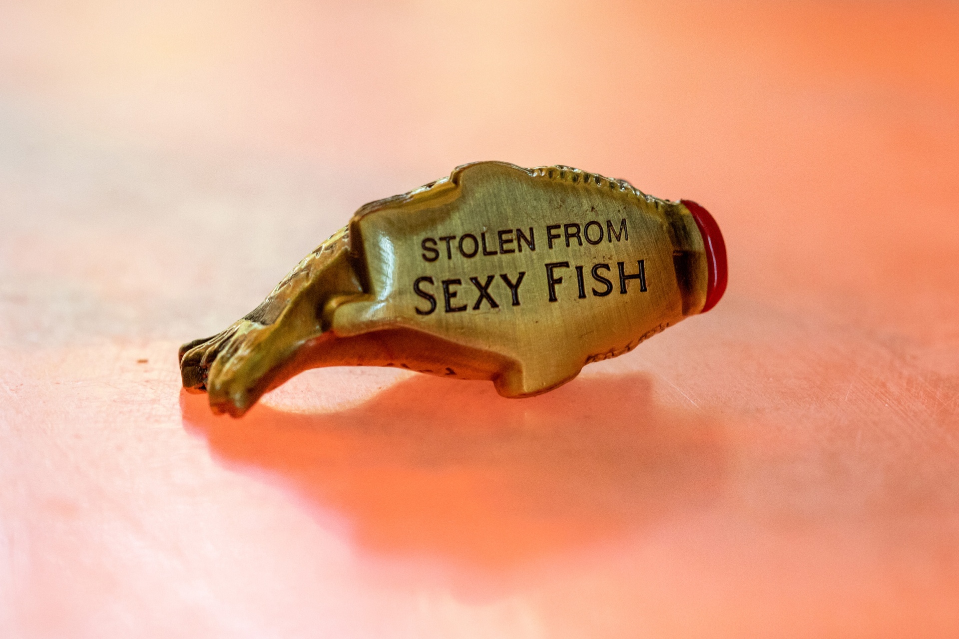 Button of a yellow fish with a red mouth