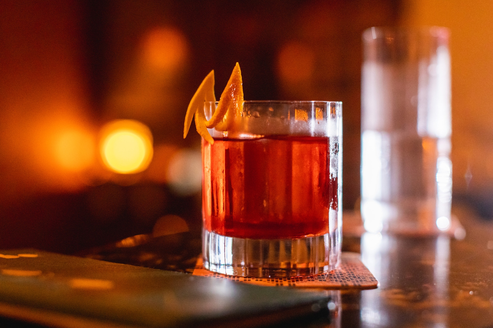 Blood orange alcohol drink in a dimly lit bar