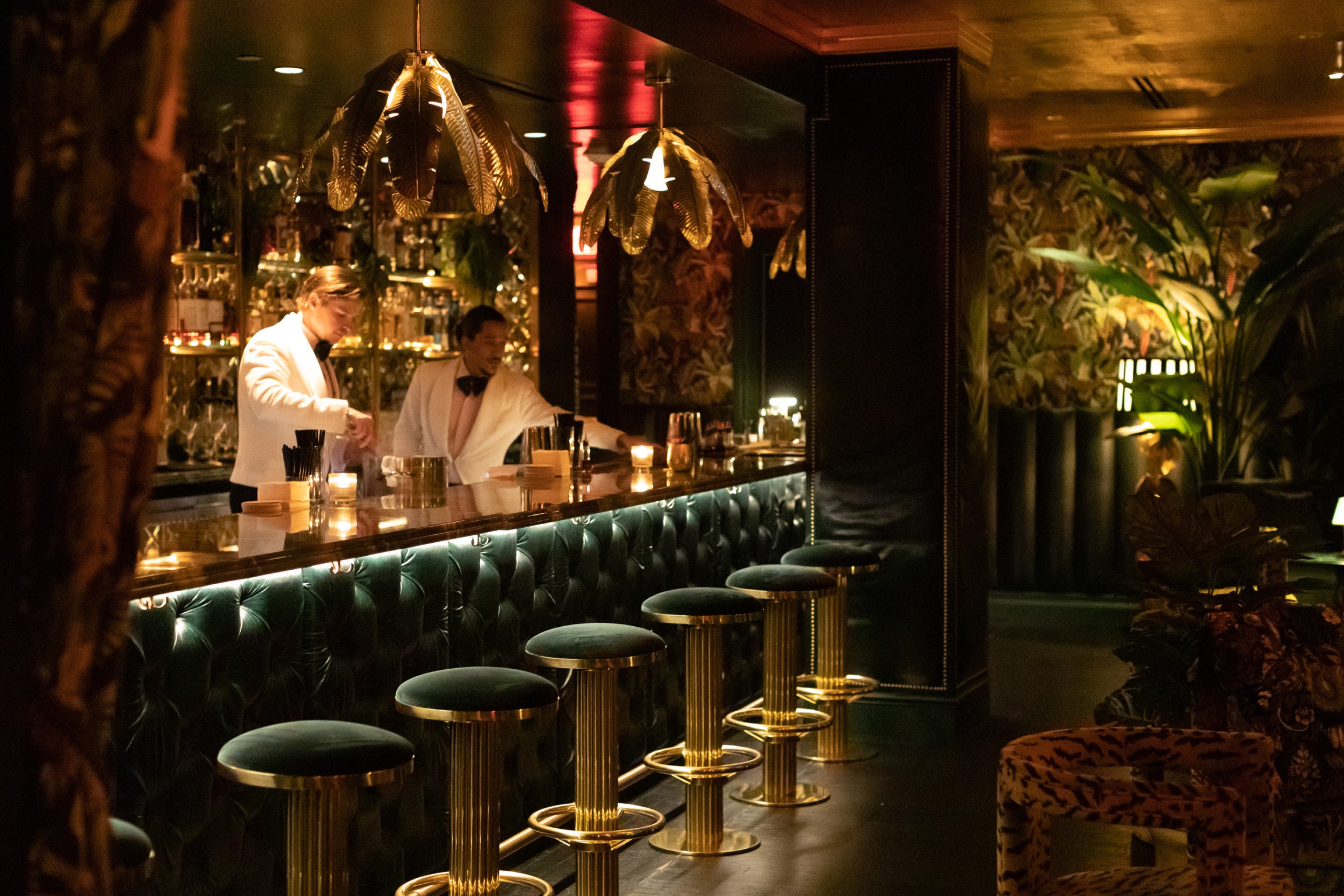 Bartenders in a classic tropical themed bar