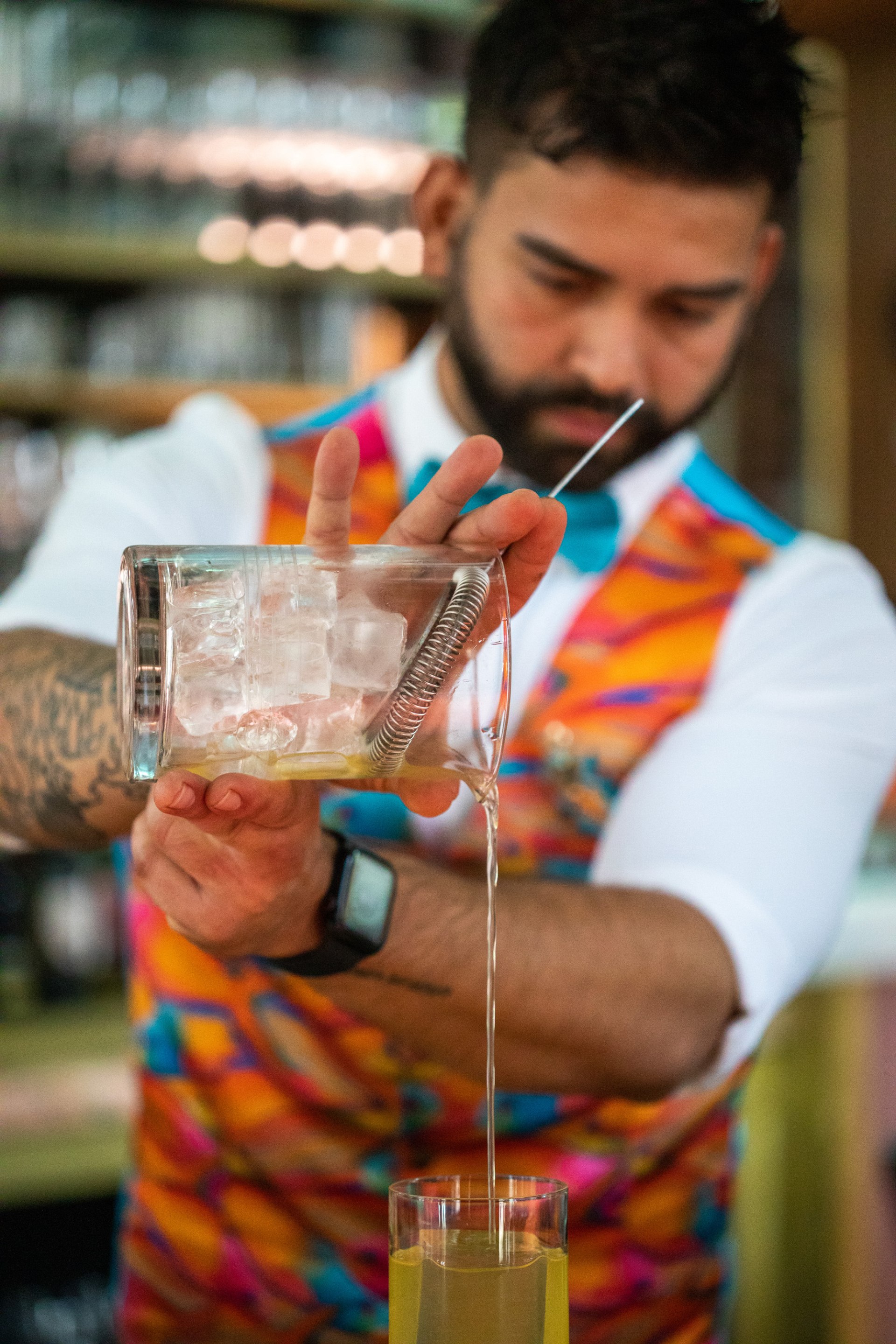 Bartender pouring a fruity tropical alcohol drink
