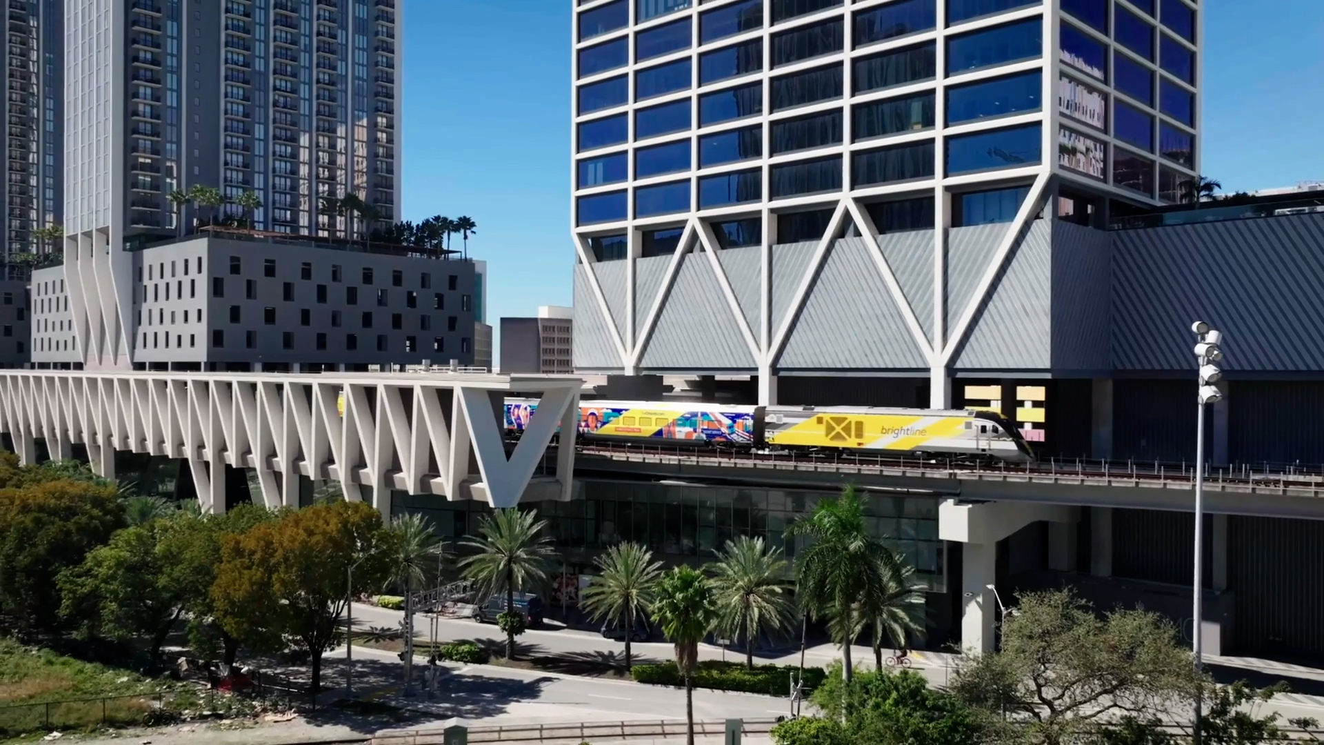 Brightline train running alongside luxury Miami hotels